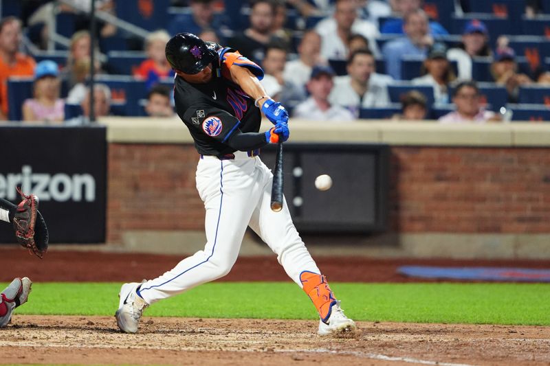 Jul 10, 2024; New York City, New York, USA; New York Mets center fielder Tyrone Taylor (15) hits a single against the Washington Nationals during the sixth inning at Citi Field. Mandatory Credit: Gregory Fisher-USA TODAY Sports