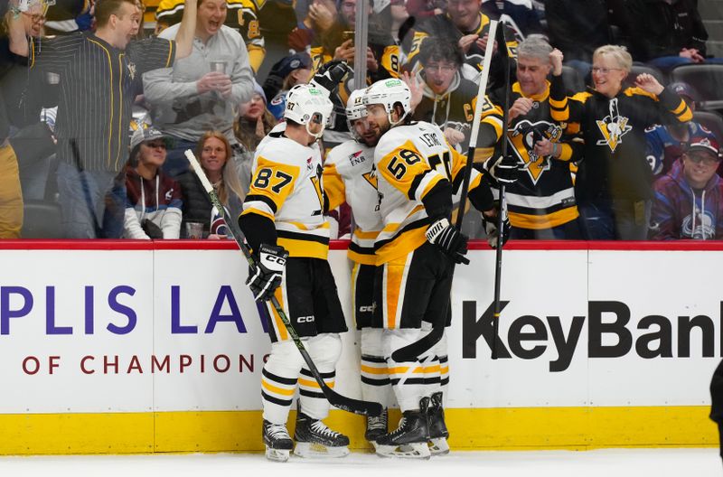Mar 24, 2024; Denver, Colorado, USA; Pittsburgh Penguins right wing Bryan Rust (17) (center) celebrates his goal with center Sidney Crosby (87) and defenseman Kris Letang (58) in the first period against the Colorado Avalanche at Ball Arena. Mandatory Credit: Ron Chenoy-USA TODAY Sports