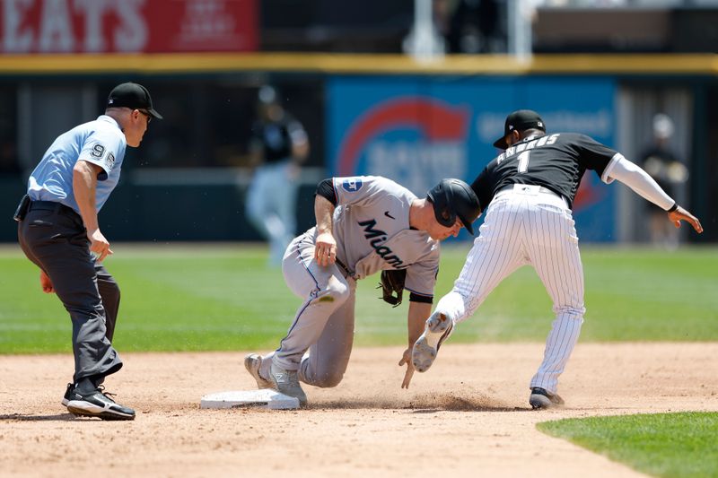 Jun 10, 2023; Chicago, Illinois, USA; Miami Marlins shortstop Joey Wendle (18) steals second base against the Chicago White Sox shortstop Elvis Andrus (1) waits for the ball during the second inning at Guaranteed Rate Field. Mandatory Credit: Kamil Krzaczynski-USA TODAY Sports