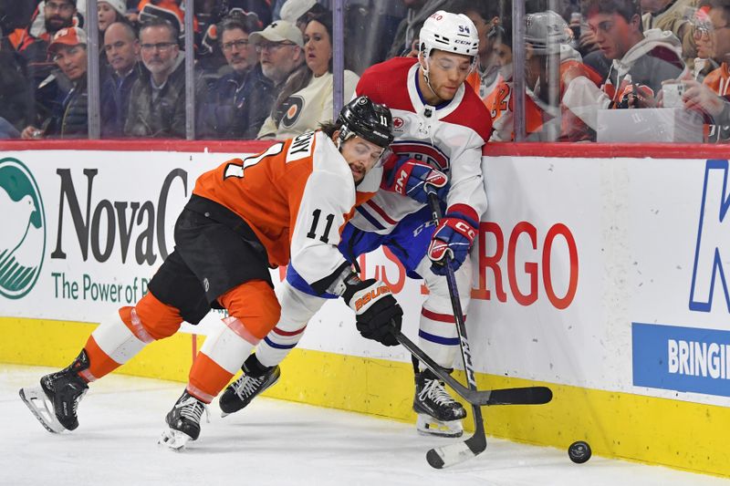 Jan 10, 2024; Philadelphia, Pennsylvania, USA; Philadelphia Flyers center Sean Couturier (14) and Montreal Canadiens defenseman Jordan Harris (54) battle for the puck during third period at Wells Fargo Center. Mandatory Credit: Eric Hartline-USA TODAY Sports