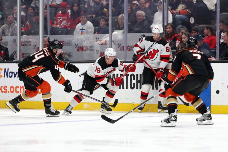 Mar 1, 2024; Anaheim, California, USA; New Jersey Devils left wing Ondrej Palat (18) and Anaheim Ducks left wing Ross Johnston (44) chase the puck during the third period at Honda Center. Mandatory Credit: Kiyoshi Mio-USA TODAY Sports