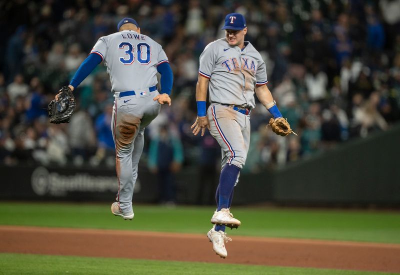 Sep 30, 2023; Seattle, Washington, USA; Texas Rangers third baseman Josh Jung (6), right, and first baseman Nathaniel Lowe (30) celebrate clinching a playoff berth against the Seattle Mariners at T-Mobile Park. Mandatory Credit: Stephen Brashear-USA TODAY Sports