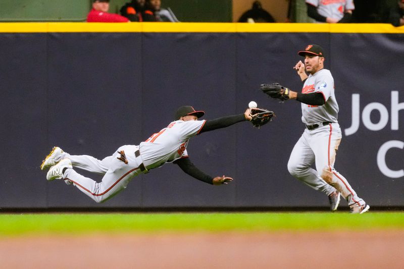 May 19, 2025; Milwaukee, Wisconsin, USA;  Baltimore Orioles center fielder Cedric Mullins (31) tries to make a diving catch on the fly ball hit by Milwaukee Brewers second baseman Brice Turang (2) (not pictured) during the fifth inning at American Family Field. Mandatory Credit: Jeff Hanisch-Imagn Images