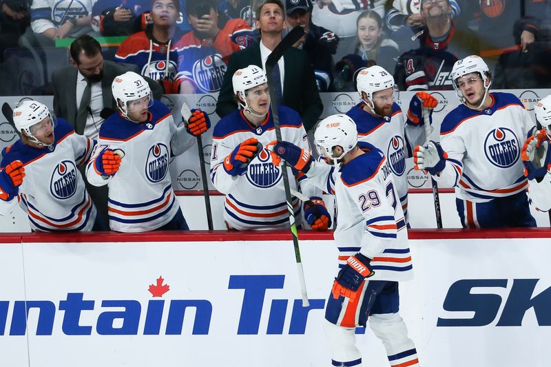 Nov 30, 2023; Winnipeg, Manitoba, CAN; Edmonton Oilers forward Leon Draisaitl (29) is congratulated by his team mates on his goal against the Winnipeg Jets during the third period at Canada Life Centre. Mandatory Credit: Terrence Lee-USA TODAY Sports