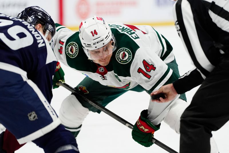 Jan 20, 2025; Denver, Colorado, USA; Minnesota Wild center Joel Eriksson Ek (14) prepares to take a face off  in the third period against the Colorado Avalanche at Ball Arena. Mandatory Credit: Ron Chenoy-Imagn Images