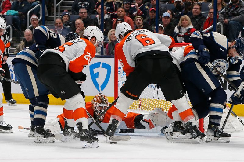 Jan 14, 2025; Columbus, Ohio, USA; Columbus Blue Jackets left wing Mikael Pyyhtia (82) reaches for the rebound of a Philadelphia Flyers goalie Ivan Fedotov (82) save during the third period at Nationwide Arena. Mandatory Credit: Russell LaBounty-Imagn Images