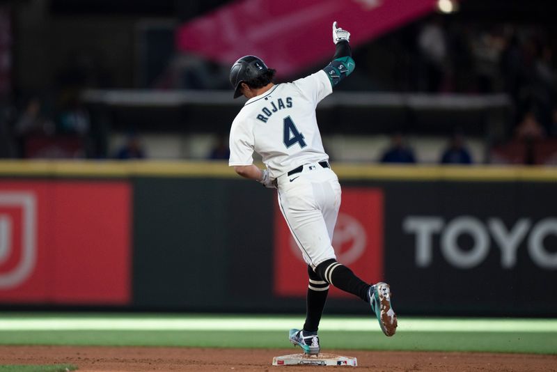 Jun 15, 2024; Seattle, Washington, USA; Seattle Mariners third baseman Josh Rojas (4) celebrates while rounding the bases after hittng a solo home run during the seventh inning against the Texas Rangers at T-Mobile Park. Mandatory Credit: Stephen Brashear-USA TODAY Sports