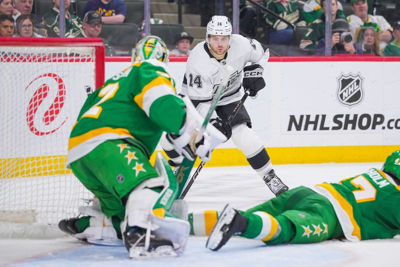 Mar 17, 2025; Saint Paul, Minnesota, USA;  Los Angeles Kings right wing Alex Laferriere (14) skates with the puck against the Minnesota Wild goaltender Filip Gustavsson (32) in the second period at Xcel Energy Center. Mandatory Credit: Brad Rempel-Imagn Images