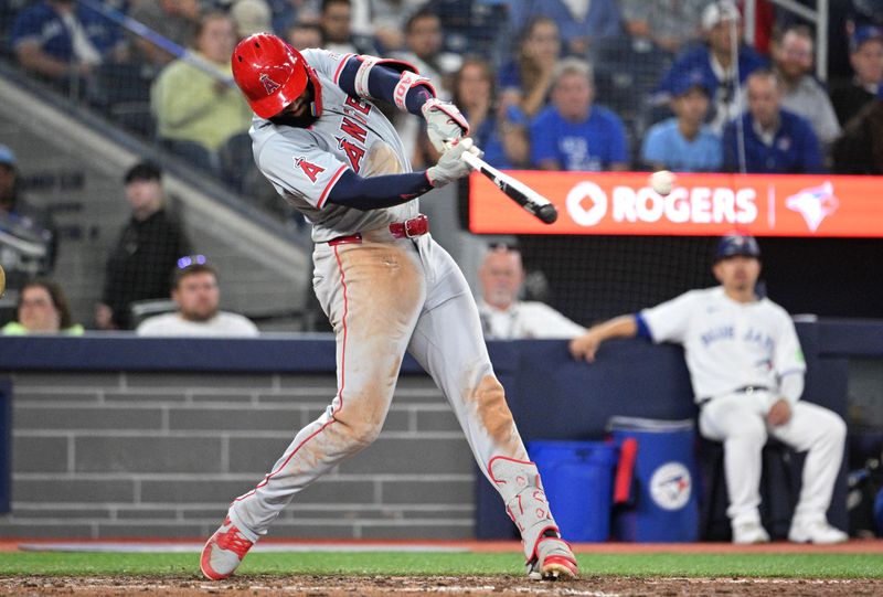 Aug 22, 2024; Toronto, Ontario, CAN;  Los Angeles Angels right fielder Jo Adell (7) hits a double against the Toronto Blue Jays in the ninth inning at Rogers Centre. Mandatory Credit: Dan Hamilton-USA TODAY Sports