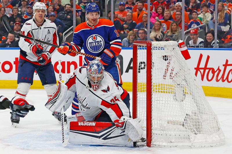 Mar 13, 2024; Edmonton, Alberta, CAN; Edmonton Oilers forward Zach Hyman (18) watches a shot by Edmonton Oilers forward Leon Draisaitl (29) (not shown) gets past Washington Capitals goaltender Darcy Kuemper (35) during the first period at Rogers Place. Mandatory Credit: Perry Nelson-USA TODAY Sports