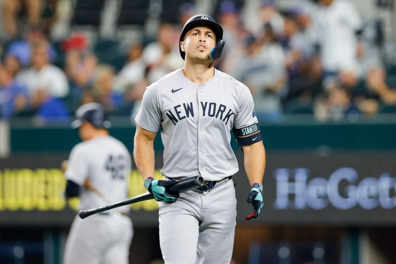 Sep 4, 2024; Arlington, Texas, USA; New York Yankees designated hitter Giancarlo Stanton (27) heads to the dugout after striking out during the fifth inning against the Texas Rangers at Globe Life Field. Mandatory Credit: Andrew Dieb-Imagn Images