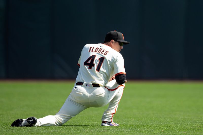 Sep 27, 2025; San Francisco, California, USA; San Francisco Giants designated hitter Wilmer Flores (41) stretches before a game against the Colorado Rockies at Oracle Park. Mandatory Credit: D. Ross Cameron-Imagn Images