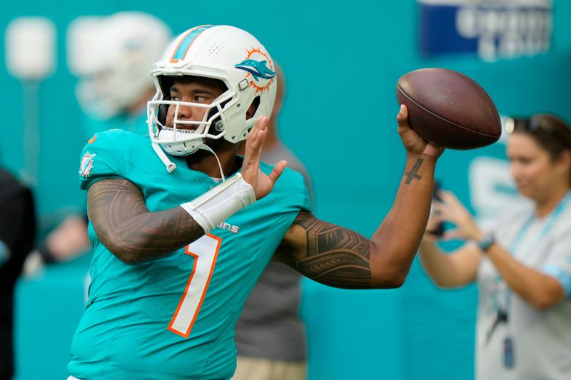 Miami Dolphins quarterback Tua Tagovailoa (1) warms up before a preseason NFL football game against the Washington Commanders, Saturday, Aug. 17, 2024, in Miami Gardens, Fla. (AP Photo/Wilfredo Lee)