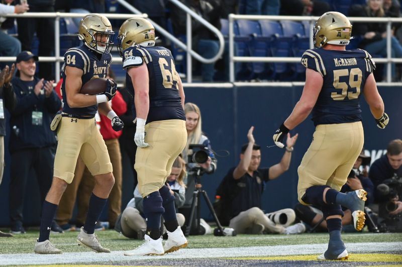 Nov 11, 2023; Annapolis, Maryland, USA; Navy Midshipmen wide receiver Regis Velez (84) celebrates with  guard Ben Purvis (64) after scoring a first half touchdown against the UAB Blazers  at Navy-Marine Corps Memorial Stadium. Mandatory Credit: Tommy Gilligan-USA TODAY Sports