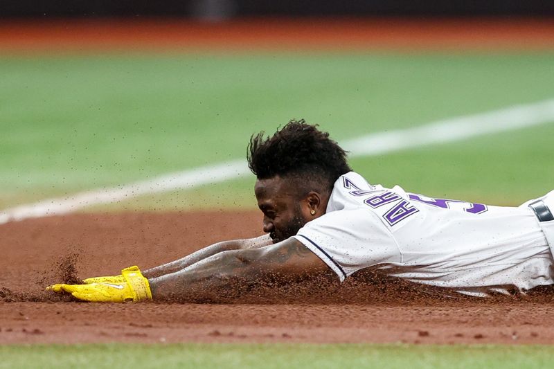 May 19, 2023; St. Petersburg, Florida, USA;  Tampa Bay Rays left fielder Randy Arozarena (56) attempts to steal third base against the Milwaukee Brewers in the fourth inning at Tropicana Field. Mandatory Credit: Nathan Ray Seebeck-USA TODAY Sports