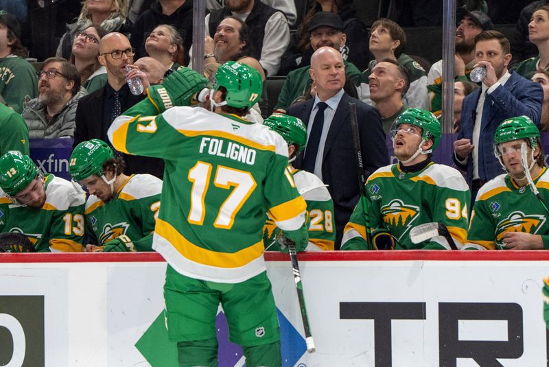 Jan 25, 2025; Saint Paul, Minnesota, USA; Minnesota Wild head coach John Hynes talks with players during a stop in the action against the Calgary Flames in the third period at Xcel Energy Center. Mandatory Credit: Matt Blewett-Imagn Images