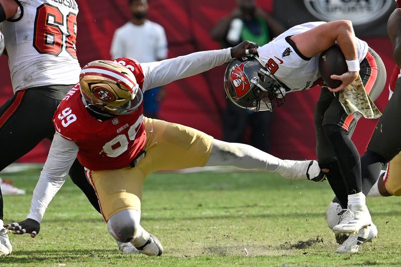 Tampa Bay Buccaneers quarterback Baker Mayfield (6) avoids a sack by San Francisco 49ers defensive tackle Maliek Collins (99) during the second half of an NFL football game in Tampa, Fla., Sunday, Nov. 10, 2024. (AP Photo/Jason Behnken)