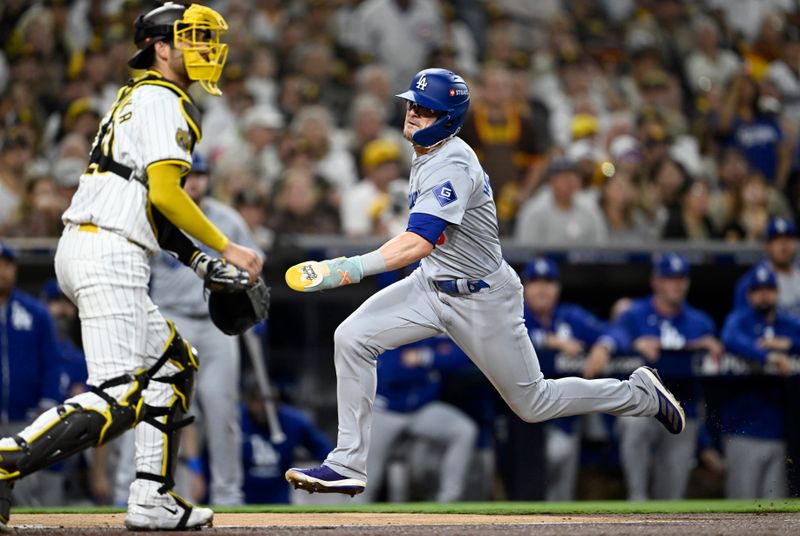 Oct 9, 2024; San Diego, California, USA; Los Angeles Dodgers third baseman Enrique Hernandez (8) scores against San Diego Padres catcher Kyle Higashioka (20) in the second inning during game four of the NLDS for the 2024 MLB Playoffs at Petco Park.  Mandatory Credit: Denis Poroy-Imagn Images