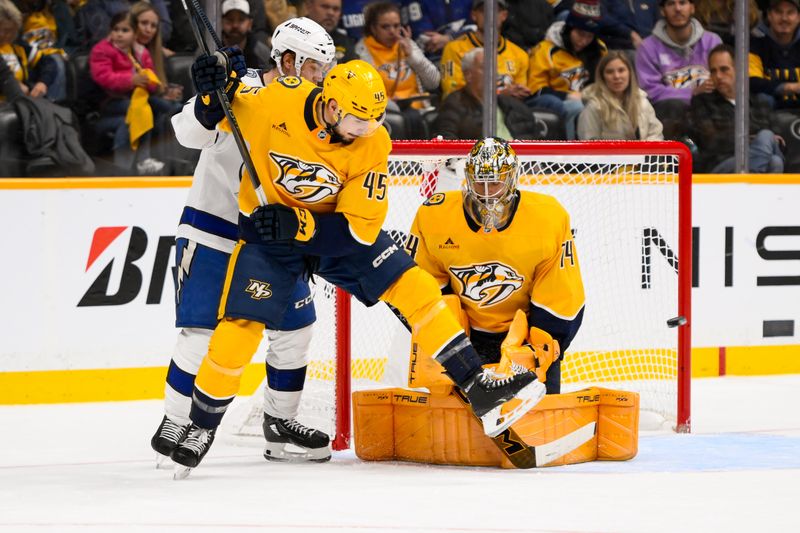 Nov 29, 2024; Nashville, Tennessee, USA;  Nashville Predators goaltender Juuse Saros (74) blocks the deflection from Tampa Bay Lightning center Anthony Cirelli (71) during the first period at Bridgestone Arena. Mandatory Credit: Steve Roberts-Imagn Images