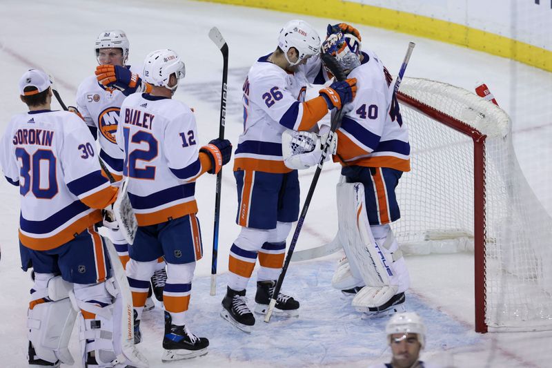 Nov 8, 2022; New York, New York, USA; New York Islanders right wing Oliver Wahlstrom (26) embraces New York Islanders goaltender Semyon Varlamov (40) after defeating the New York Rangers at Madison Square Garden. Mandatory Credit: Jessica Alcheh-USA TODAY Sports