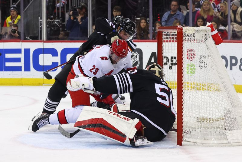 Mar 9, 2024; Newark, New Jersey, USA; New Jersey Devils goaltender Nico Daws (50) makes a save against the Carolina Hurricanes during the first period at Prudential Center. Mandatory Credit: Ed Mulholland-USA TODAY Sports