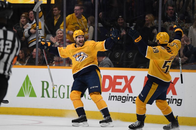 Nov 28, 2023; Nashville, Tennessee, USA; Nashville Predators left wing Filip Forsberg (9) celebrates with defenseman Roman Josi (59)after scoring the game-winning goal in overtime against the Pittsburgh Penguins at Bridgestone Arena. Mandatory Credit: Christopher Hanewinckel-USA TODAY Sports