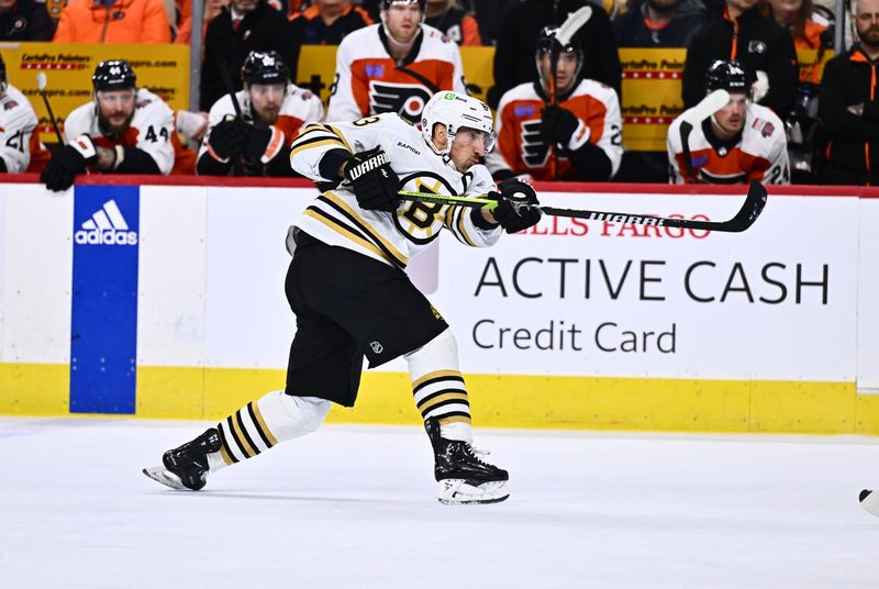 Jan 27, 2024; Philadelphia, Pennsylvania, USA; Boston Bruins left wing Brad Marchand (63) shoots against the Philadelphia Flyers in the first period at Wells Fargo Center. Mandatory Credit: Kyle Ross-USA TODAY Sports