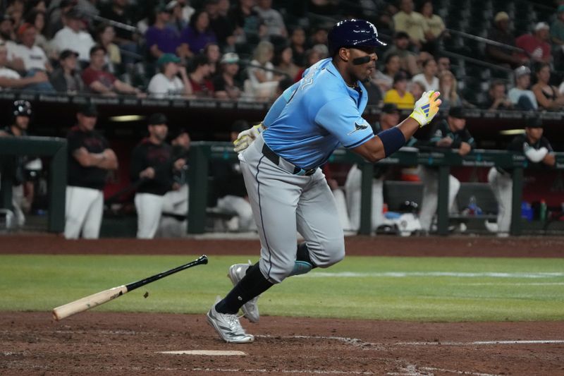 Apr 23, 2025; Phoenix, Arizona, USA; Tampa Bay Rays first base Yandy Díaz (2) hits an RBI double against the Arizona Diamondbacks during the eleventh inning at Chase Field. Mandatory Credit: Rick Scuteri-Imagn Images