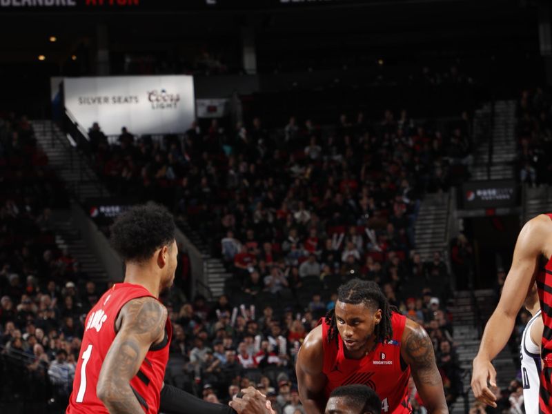 PORTLAND, OR - NOVEMBER 29: Deandre Ayton #2 is helped up by Anfernee Simons #1 and Jabari Walker #34 of the Portland Trail Blazers during the game against the Sacramento Kings during the Emirates NBA Cup on November 29, 2024 at the Moda Center Arena in Portland, Oregon. NOTE TO USER: User expressly acknowledges and agrees that, by downloading and or using this photograph, user is consenting to the terms and conditions of the Getty Images License Agreement. Mandatory Copyright Notice: Copyright 2024 NBAE (Photo by Cameron Browne/NBAE via Getty Images)