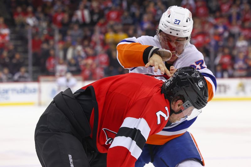 Nov 28, 2023; Newark, New Jersey, USA; New York Islanders left wing Anders Lee (27) and New Jersey Devils defenseman Brendan Smith (2) fight during the third period at Prudential Center. Mandatory Credit: Ed Mulholland-USA TODAY Sports