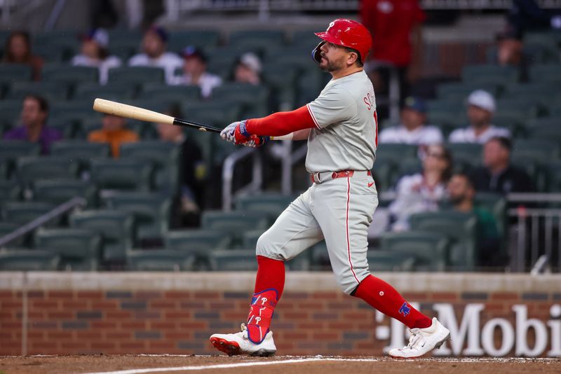 Apr 10, 2025; Atlanta, Georgia, USA; Philadelphia Phillies designated hitter Kyle Schwarber (12) hits a home run against the Atlanta Braves in the third inning at Truist Park. Mandatory Credit: Brett Davis-Imagn Images