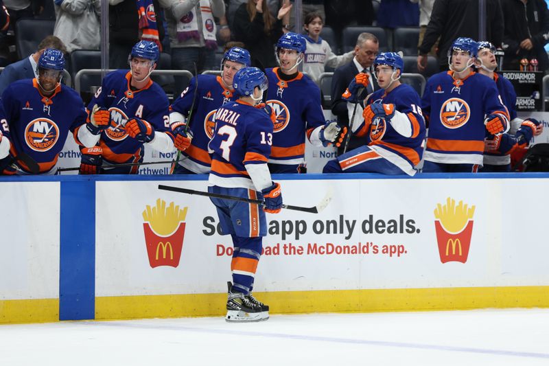 Jan 18, 2025; Elmont, New York, USA;  New York Islanders center Mathew Barzal (13) celebrates his goal against the San Jose Sharks during the second period at UBS Arena. Mandatory Credit: Thomas Salus-Imagn Images