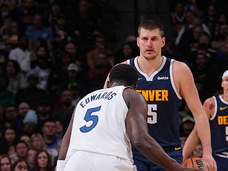 DENVER, CO - APRIL 10: Anthony Edwards #5 of the Minnesota Timberwolves handles the ball against Nikola Jokic #15 of the Denver Nuggets during the game on April 10, 2024 at the Ball Arena in Denver, Colorado. NOTE TO USER: User expressly acknowledges and agrees that, by downloading and/or using this Photograph, user is consenting to the terms and conditions of the Getty Images License Agreement. Mandatory Copyright Notice: Copyright 2024 NBAE (Photo by Bart Young/NBAE via Getty Images)