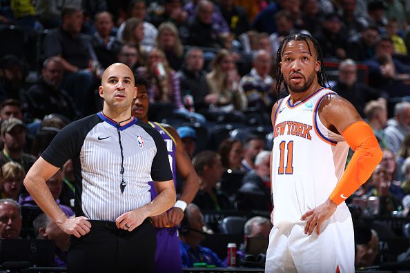 SALT LAKE CITY, UT - DECEMBER 13:  Jalen Brunson #11 of the New York Knicks & Referee Aaron Smith #51 looks on during the game on December 13, 2023 at vivint.SmartHome Arena in Salt Lake City, Utah. NOTE TO USER: User expressly acknowledges and agrees that, by downloading and or using this Photograph, User is consenting to the terms and conditions of the Getty Images License Agreement. Mandatory Copyright Notice: Copyright 2023 NBAE (Photo by Melissa Majchrzak/NBAE via Getty Images)