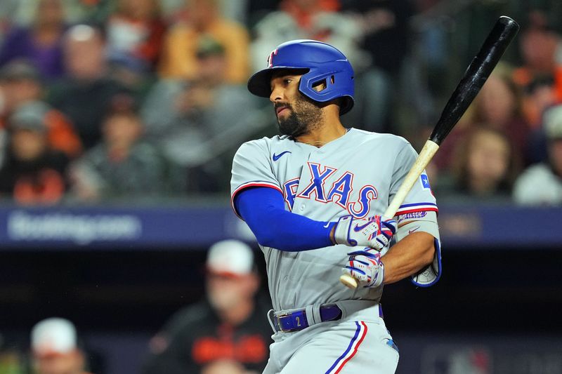 Oct 8, 2023; Baltimore, Maryland, USA; Texas Rangers second baseman Marcus Semien (2) hits an RBI during the ninth inning against the Baltimore Orioles during game two of the ALDS for the 2023 MLB playoffs at Oriole Park at Camden Yards. Mandatory Credit: Mitch Stringer-USA TODAY Sports