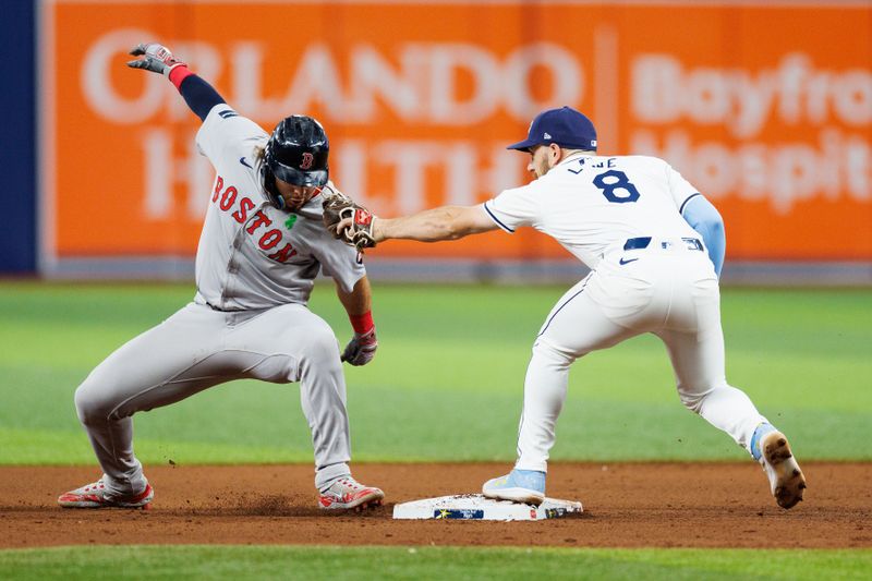 May 21, 2024; St. Petersburg, Florida, USA;  Boston Red Sox outfielder Wilyer Abreu (52) is caught stealing second base by Tampa Bay Rays second baseman Brandon Lowe (8) in the eighth inning at Tropicana Field. Mandatory Credit: Nathan Ray Seebeck-USA TODAY Sports