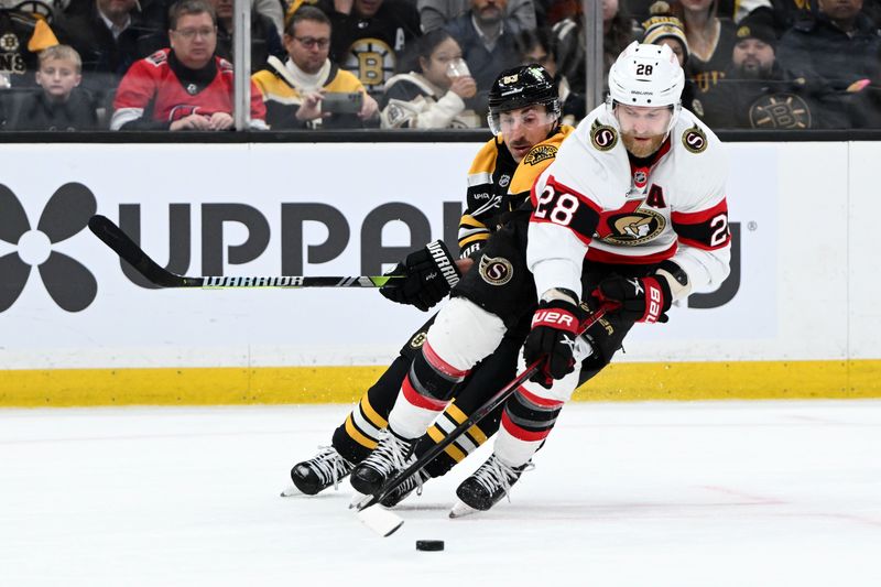 Jan 23, 2025; Boston, Massachusetts, USA; Ottawa Senators right wing Claude Giroux (28) skates with the puck in front of Boston Bruins left wing Brad Marchand (63) during the third period at the TD Garden. Mandatory Credit: Brian Fluharty-Imagn Images