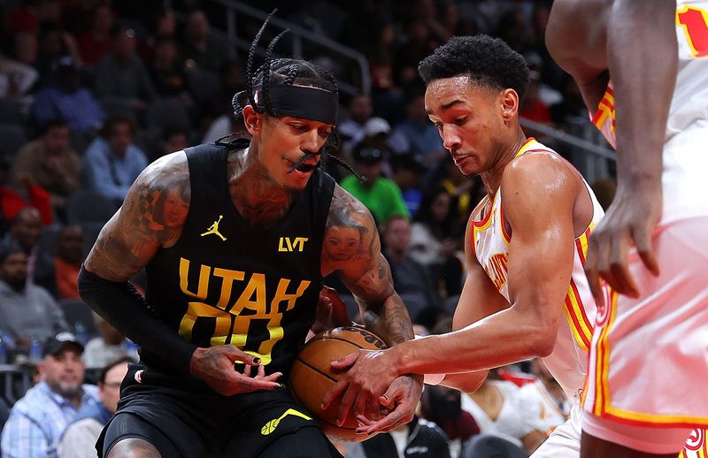 ATLANTA, GEORGIA - FEBRUARY 27:  Kobe Bufkin #4 of the Atlanta Hawks forces a jump ball as he defends against Jordan Clarkson #00 of the Utah Jazz during the fourth quarter at State Farm Arena on February 27, 2024 in Atlanta, Georgia.  NOTE TO USER: User expressly acknowledges and agrees that, by downloading and/or using this photograph, user is consenting to the terms and conditions of the Getty Images License Agreement.  (Photo by Kevin C. Cox/Getty Images)