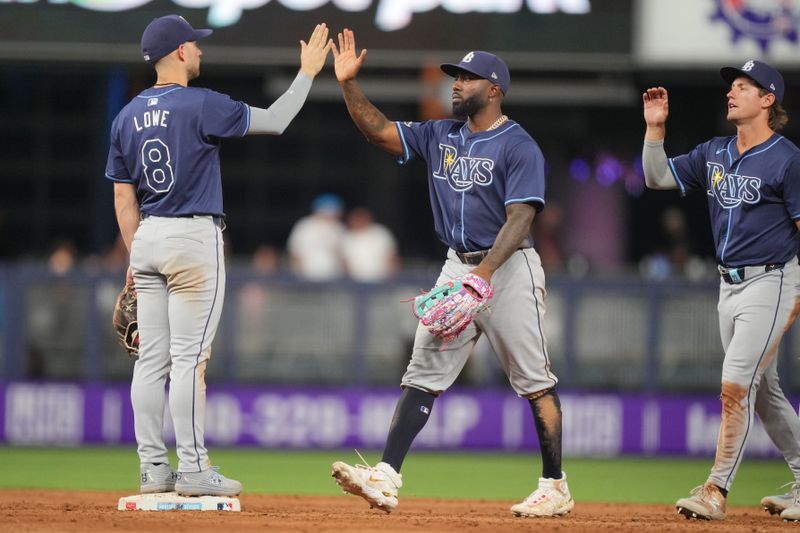 Jun 4, 2024; Miami, Florida, USA; Tampa Bay Rays second baseman Brandon Lowe (8) and left fielder Randy Arozarena (56) celebrate a victory against the Miami Marlins at loanDepot Park. Mandatory Credit: Jim Rassol-USA TODAY Sports