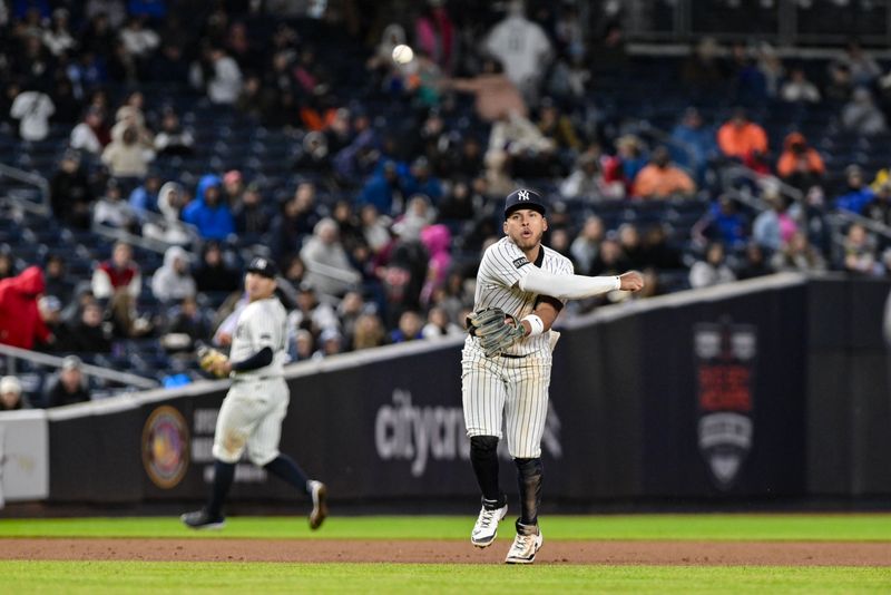 May 21, 2025; Bronx, New York, USA; New York Yankees second baseman Jorbit Vivas (90) throws to first base for an out Texas Rangers outfielder Adolis García (not pictured) during the eighth inning at Yankee Stadium. Mandatory Credit: John Jones-Imagn Images