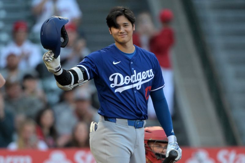 Mar 26, 2024; Anaheim, California, USA; Los Angeles Dodgers designated hitter Shohei Ohtani (17) acknowledges the crowd prior to his first at bat in the first inning against the Los Angeles Angels at Angel Stadium. Mandatory Credit: Jayne Kamin-Oncea-USA TODAY Sports