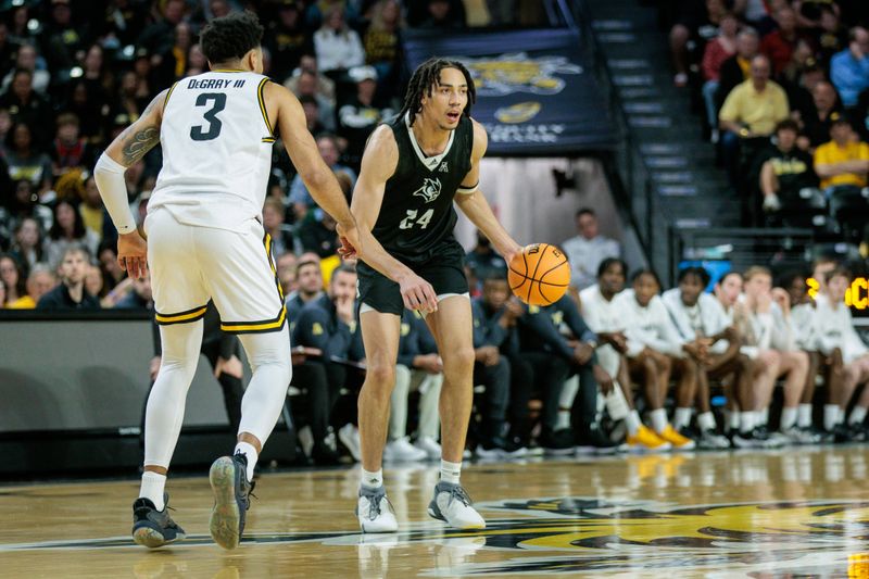 Mar 2, 2024; Wichita, Kansas, USA; Rice Owls forward Keanu Dawes (24) brings the ball up court around Wichita State Shockers forward Isaac Abidde (5) during the first half at Charles Koch Arena. Mandatory Credit: William Purnell-USA TODAY Sports