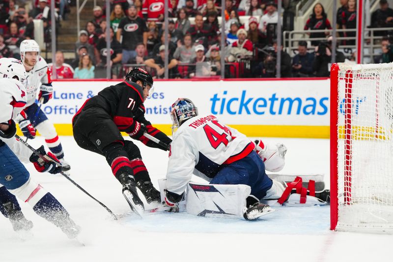 May 10, 2025; Raleigh, North Carolina, USA; Washington Capitals goaltender Logan Thompson (48) stops the scoring attempt by Carolina Hurricanes left wing Taylor Hall (71) during the third period in game three of the second round of the 2025 Stanley Cup Playoffs at Lenovo Center. Mandatory Credit: James Guillory-Imagn Images