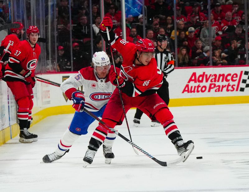 Dec 28, 2023; Raleigh, North Carolina, USA; Carolina Hurricanes left wing Teuvo Teravainen (86) makes a pass against Montreal Canadiens left wing Michael Pezzetta (55) during the second period at PNC Arena. Mandatory Credit: James Guillory-USA TODAY Sports