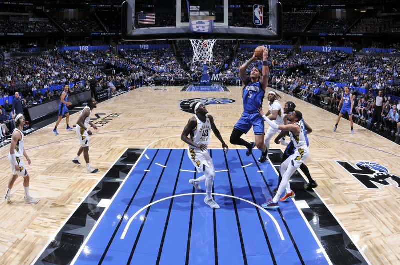 ORLANDO, FL - MARCH 10: Paolo Banchero #5 of the Orlando Magic goes to the basket during the game on March 10, 2024 at Amway Center in Orlando, Florida. NOTE TO USER: User expressly acknowledges and agrees that, by downloading and or using this photograph, User is consenting to the terms and conditions of the Getty Images License Agreement. Mandatory Copyright Notice: Copyright 2024 NBAE (Photo by Fernando Medina/NBAE via Getty Images)