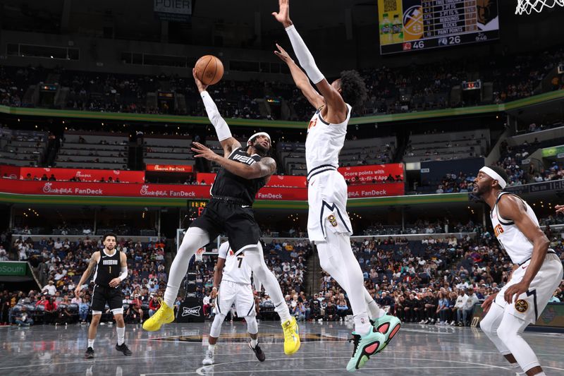 MEMPHIS, TN - APRIL 14:  Timmy Allen #0 of the Memphis Grizzlies drives to the basket during the game against the Denver Nuggets on April 14, 2024 at FedExForum in Memphis, Tennessee. NOTE TO USER: User expressly acknowledges and agrees that, by downloading and or using this photograph, User is consenting to the terms and conditions of the Getty Images License Agreement. Mandatory Copyright Notice: Copyright 2024 NBAE (Photo by Joe Murphy/NBAE via Getty Images)