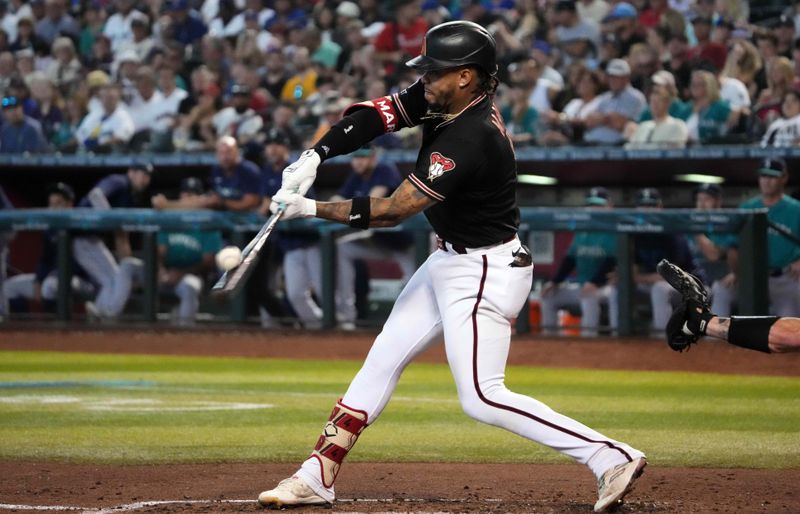 Jul 29, 2023; Phoenix, Arizona, USA; Arizona Diamondbacks second baseman Ketel Marte (4) bats against the Seattle Mariners during the fourth inning at Chase Field. Mandatory Credit: Joe Camporeale-USA TODAY Sports