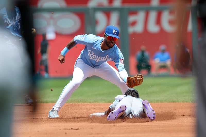 Jun 26, 2024; Kansas City, Missouri, USA; Kansas City Royals third base Maikel Garcia (11) reaches to tag Miami Marlins outfielder Jazz Chisholm Jr. (2) as he dives into second base during the first inning at Kauffman Stadium. Mandatory Credit: William Purnell-USA TODAY Sports