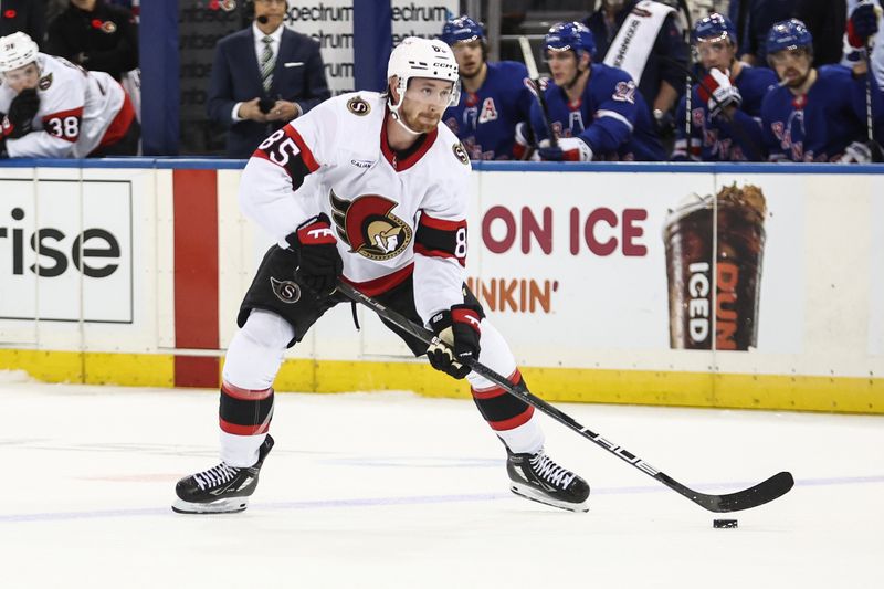 Nov 1, 2024; New York, New York, USA;  Ottawa Senators defenseman Jake Sanderson (85) controls the puck in the third period against the New York Rangers at Madison Square Garden. Mandatory Credit: Wendell Cruz-Imagn Images