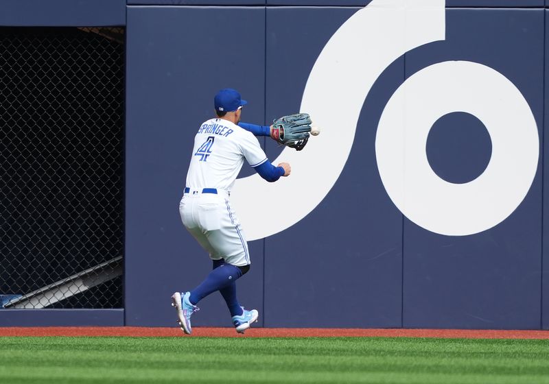 Sep 10, 2023; Toronto, Ontario, CAN; Toronto Blue Jays right fielder George Springer (4) plays a fly ball off the wall against the Kansas City Royals during the first inning at Rogers Centre. Mandatory Credit: Nick Turchiaro-USA TODAY Sports